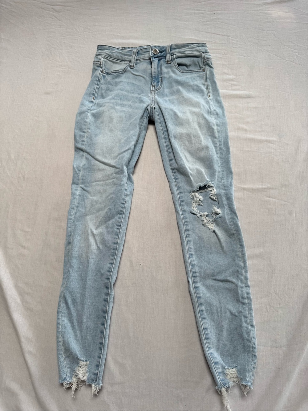 American Eagle Outfitters Light Blue Skinny Jeans with Distressed Knees